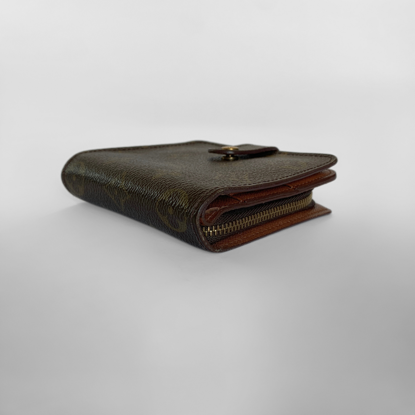 Brown leather wallet with a gold zipper on a white background