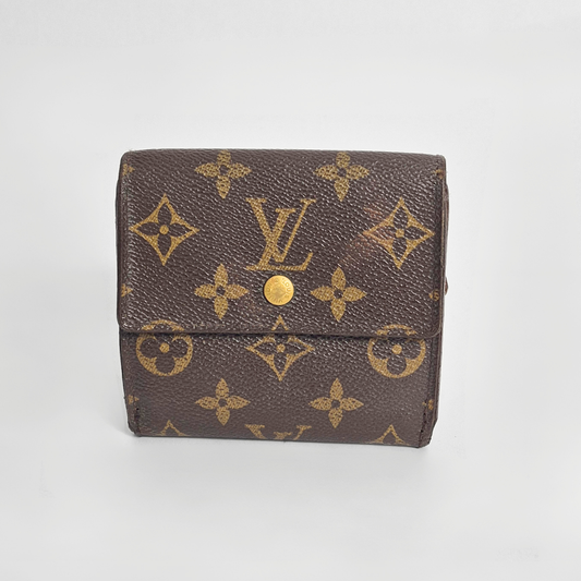 Louis Vuitton wallet with monogram pattern on a light gray background