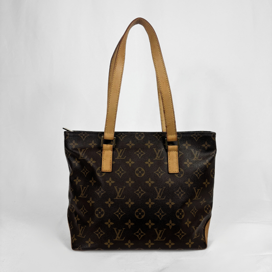 A Louis Vuitton monogram canvas tote bag with tan leather shoulder straps, photographed against a plain white background.