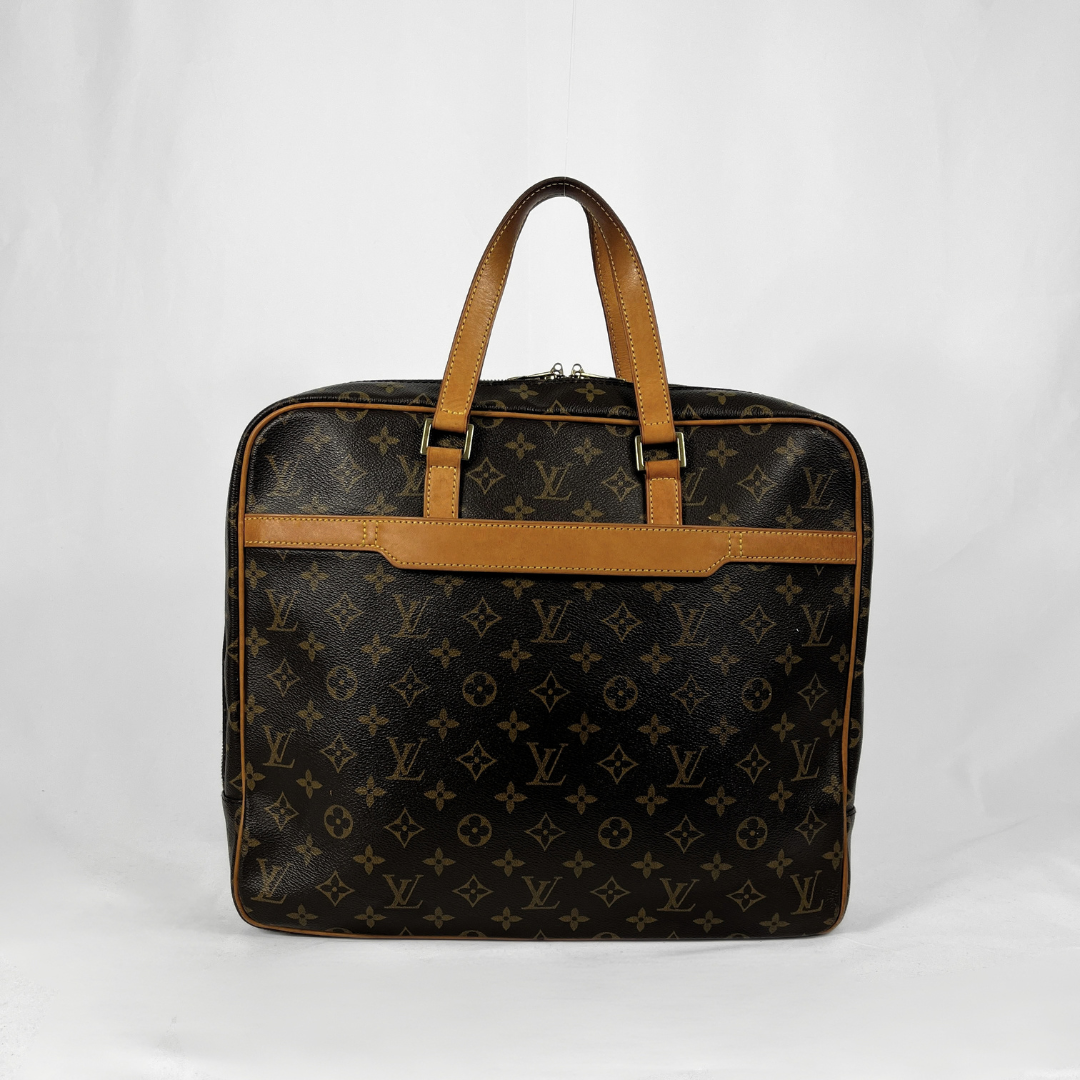 Louis Vuitton monogram canvas briefcase or laptop bag with tan leather handles and trim, photographed against a plain white studio background.