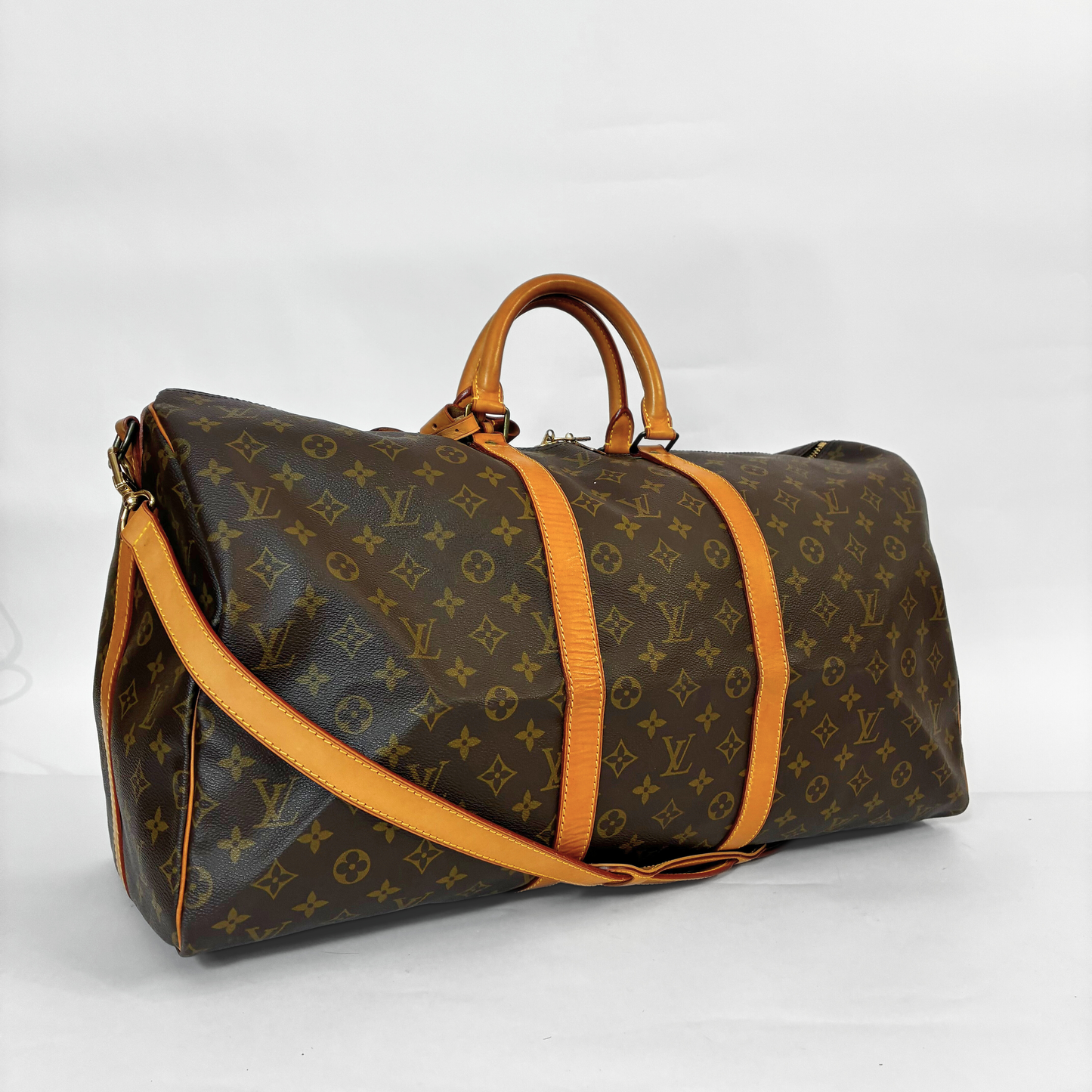 Designer travel bag with monogram pattern on a white background