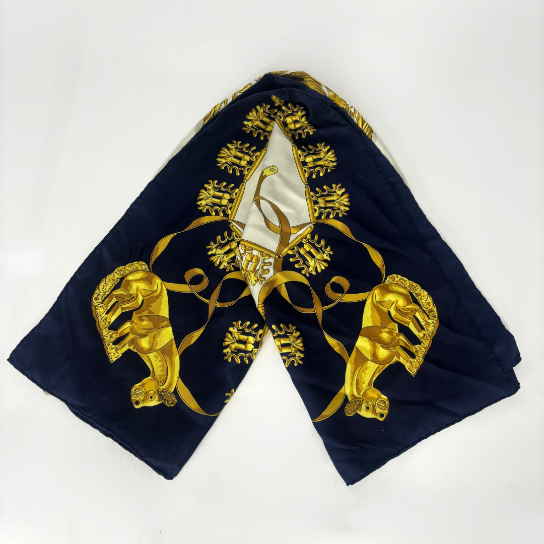 Navy blue fabric with gold embroidery featuring a central emblem and two lion-like figures on a white background