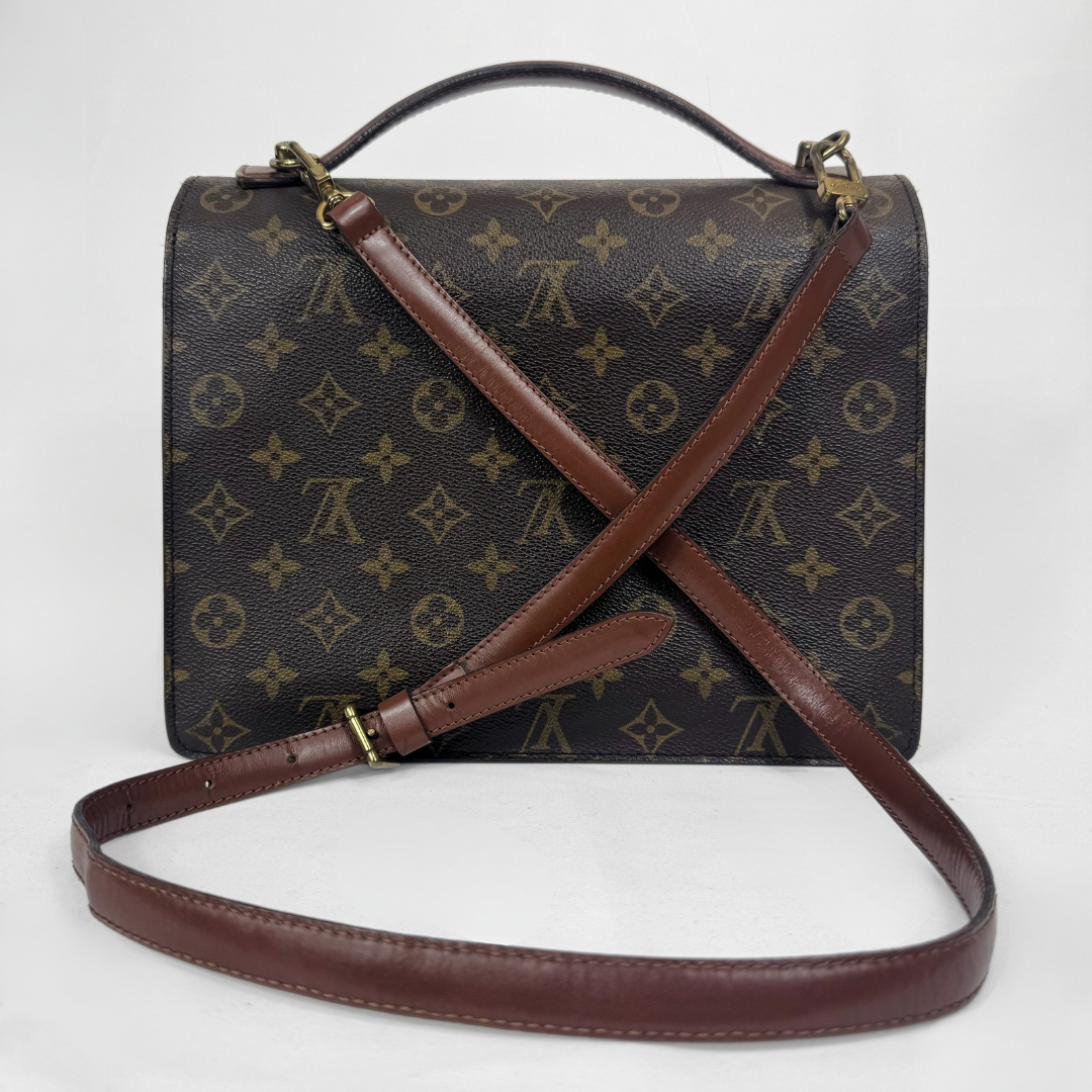 A Louis Vuitton monogram canvas handbag with dark brown leather trim, a top handle, and a long adjustable shoulder strap, photographed against a plain white background.
