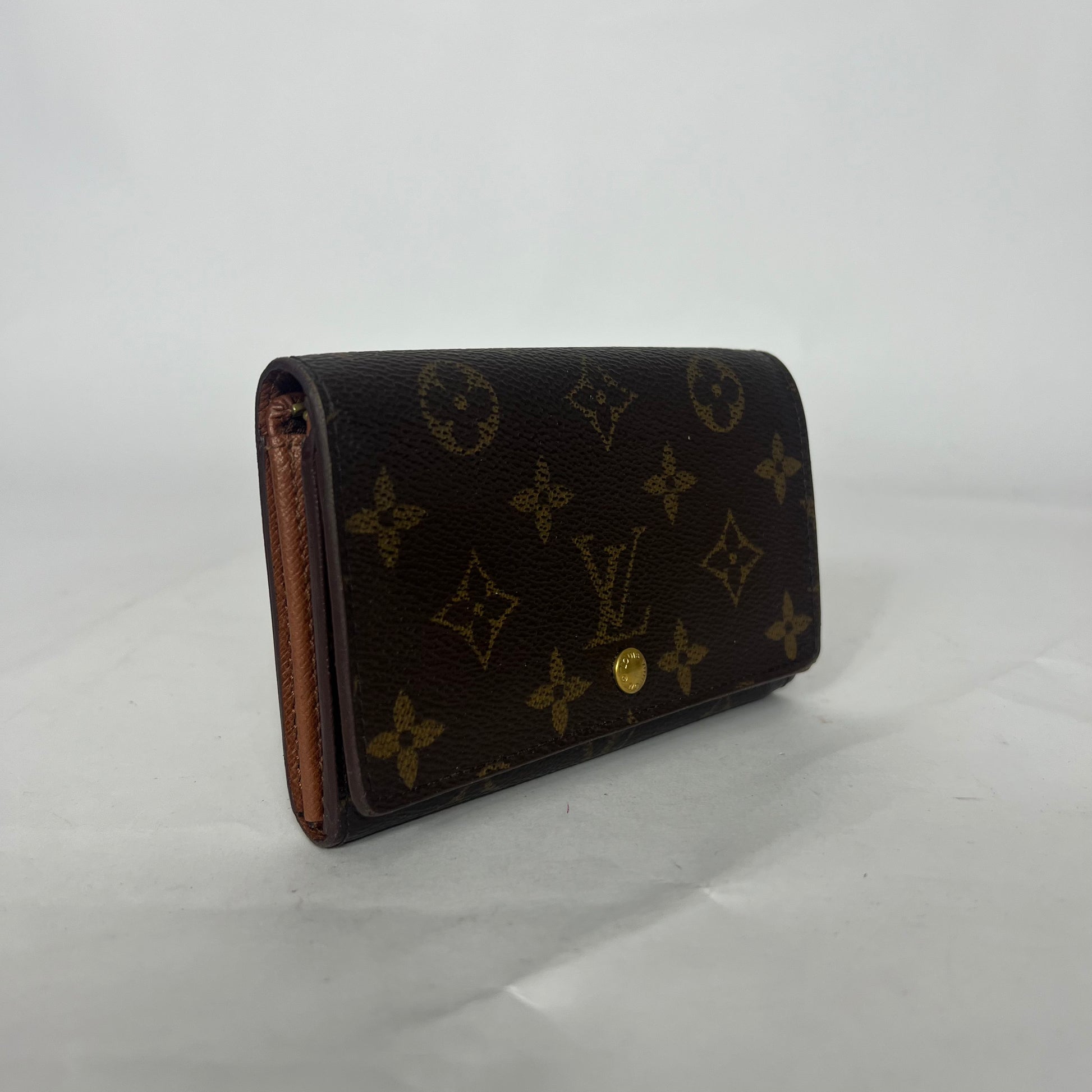 Designer wallet with monogram pattern on a white background
