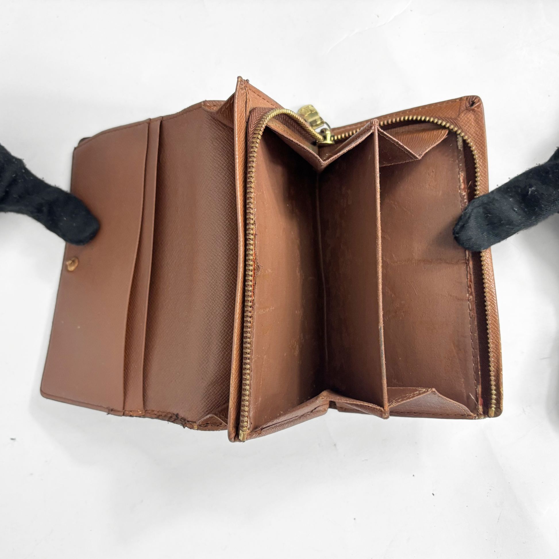 Louis vuitton wallet in brown Damier Ebene checkered canvas with a snap-button closure.